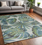 5' X 8' Beige Teal And Green Tropical Botanical Area Rug