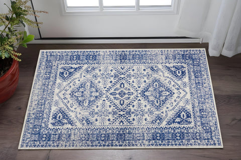 6' X 9' Ivory And Blue Geometric Distressed Area Rug