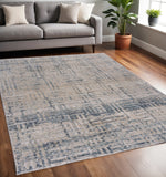 5' X 8' Cream Blue And Ivory Geometric Distressed Stain Resistant Area Rug