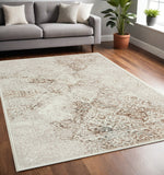 5' X 7' Beige Cream And Brown Damask Stain Resistant Area Rug