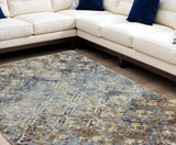 5' X 8' Brown Light Blue And Gray Distressed Diamond Area Rug