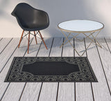 2' X 4' Black and Ivory Stain Resistant Indoor Outdoor Area Rug