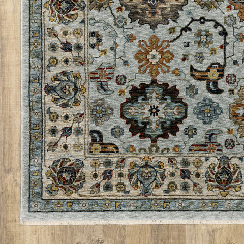 5' X 8' Blue Beige Grey Green Yellow And Rust Oriental Power Loom Stain Resistant Area Rug With Fringe