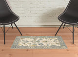 2' X 3' Ivory Blue Grey Teal Gold Green And Rust Oriental Power Loom Stain Resistant Area Rug With Fringe
