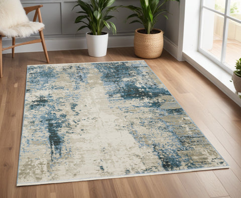 4' X 6' Blue Grey Ivory Light Blue And Dark Blue Abstract Power Loom Stain Resistant Area Rug With Fringe