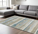 6' X 9' Ivory Beige Grey Blue And Tan Abstract Power Loom Stain Resistant Area Rug With Fringe
