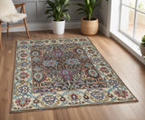 4' X 6' Ivory and Blue Wool Floral Hand Knotted Distressed Area Rug With Fringe