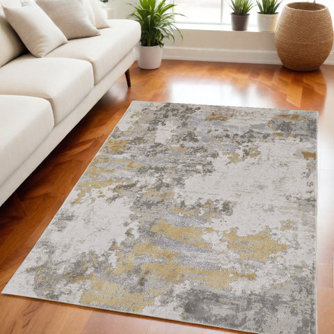 5' X 8' Ivory Gray And Gold Abstract Area Rug