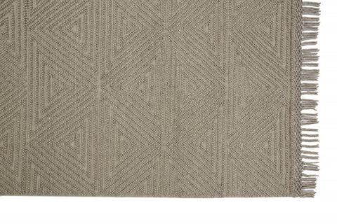 5' X 8' Tan And Ivory Wool Geometric Hand Woven Area Rug With Fringe
