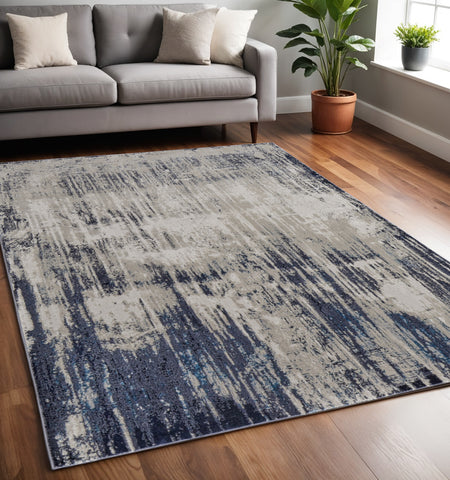 5' X 8' Tan Blue And Ivory Abstract Power Loom Distressed Area Rug