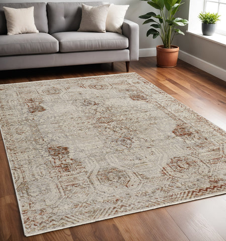 5' X 8' Tan and Ivory Floral Power Loom Distressed Non Skid Area Rug With Fringe