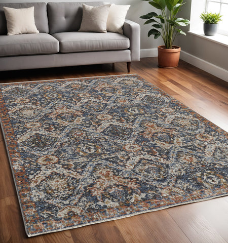5' X 8' Ivory Blue And Burnt Orange Floral Area Rug With Fringe
