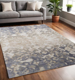 5' X 8' Ivory Tan And Blue Abstract Distressed Area Rug