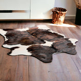 5' X 7' Brown and White Cowhide Hand Knotted Area Rug