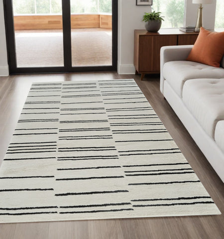 5' X 8' Cream and Black Abstract Worn Faded Area Rug