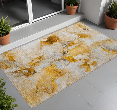2' X 3' Orange and Ivory Abstract Washable Indoor Outdoor Area Rug