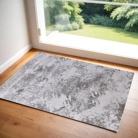 2' X 3' Tan and Ivory Abstract Power Loom Worn Faded Area Rug