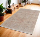 4' X 6' Tan Orange and Ivory Oriental Hand Woven Distressed Area Rug With Fringe