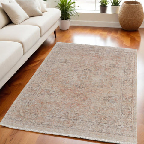 5' X 8' Tan Orange and Ivory Oriental Hand Woven Distressed Area Rug With Fringe