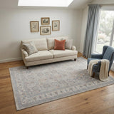 5' X 7' Silver Taupe and Blue Oriental Power Loom Worn Faded Area Rug With Fringe