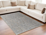 5' X 8' Ivory Tan and Blue Abstract Power Loom Worn Faded Area Rug With Fringe