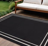 7' X 10' Black And Ivory Indoor Outdoor Area Rug